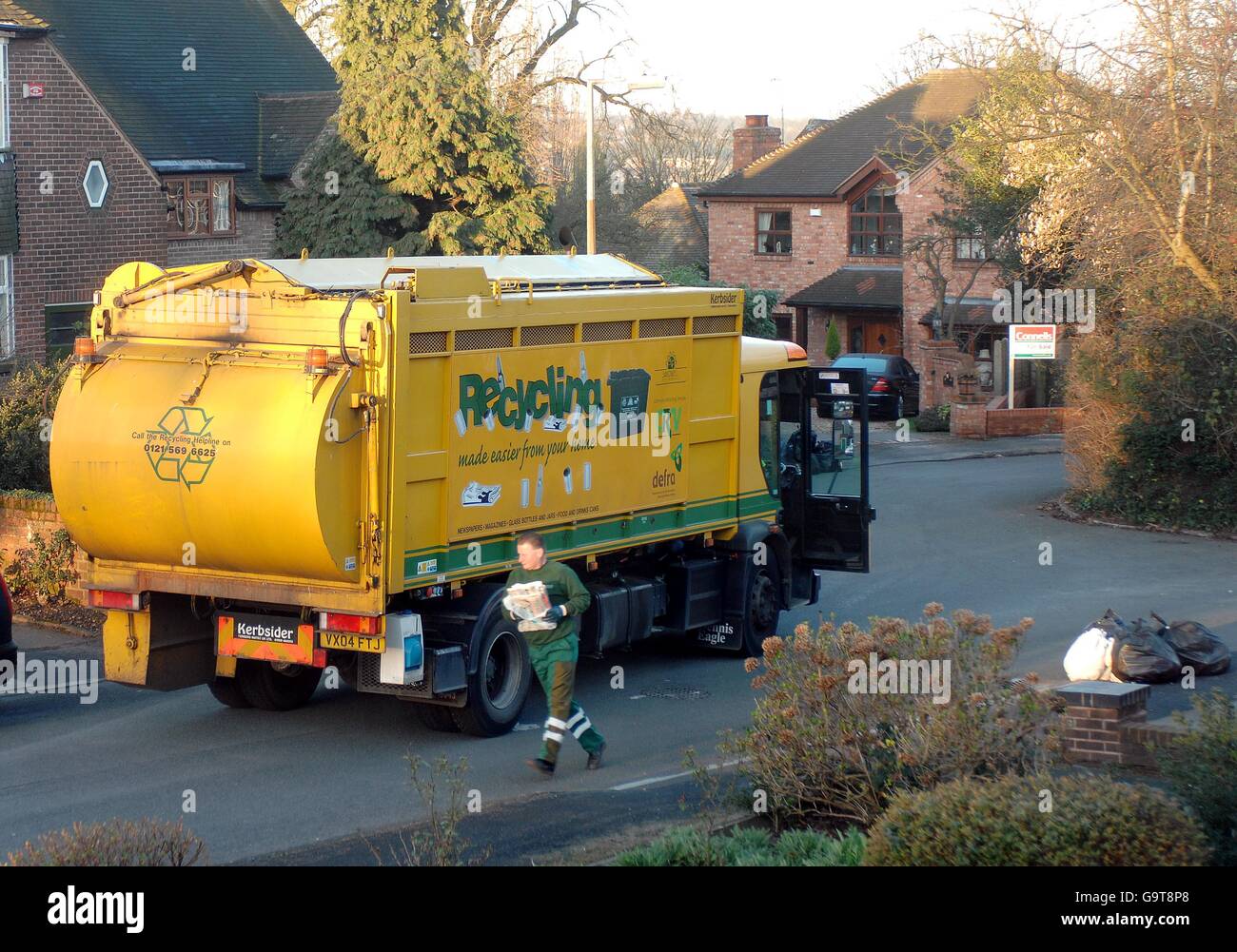 A refuse vehicle in Sandwell, West Midlands, collects domestic rubbish for recycling. Stock Photo