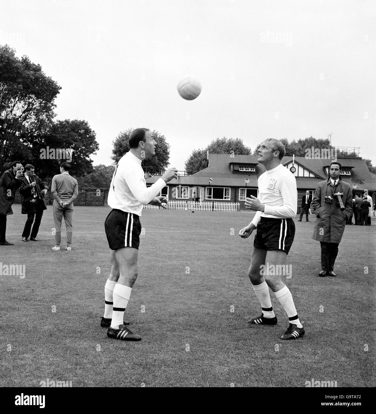 (L-R) Fulham's George Cohen and Frank Large head the ball back and forth to each other Stock Photo