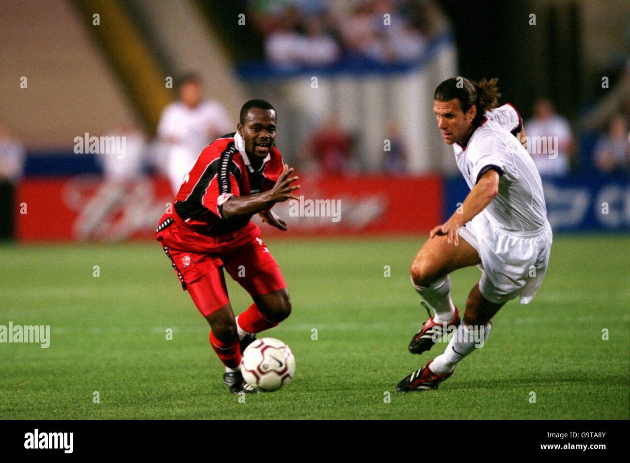 Soccer - World Cup 2002 Qualifier - CONCACAF Section - Final Group - USA v Trinidad and Tobago. Trinidad and Tobago's Stern John (l) takes on the USA's Jeff Agoos (r) Stock Photo