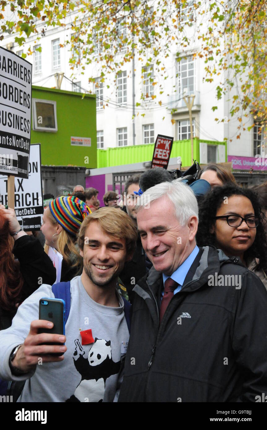 A student takes a selfie with Shadow Home Chancellor, John McDonnell, at the students' march against further cuts to education. Stock Photo