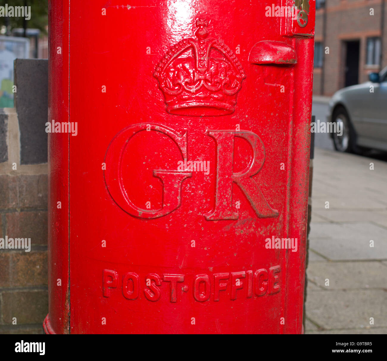 Bright red post box UK Stock Photo