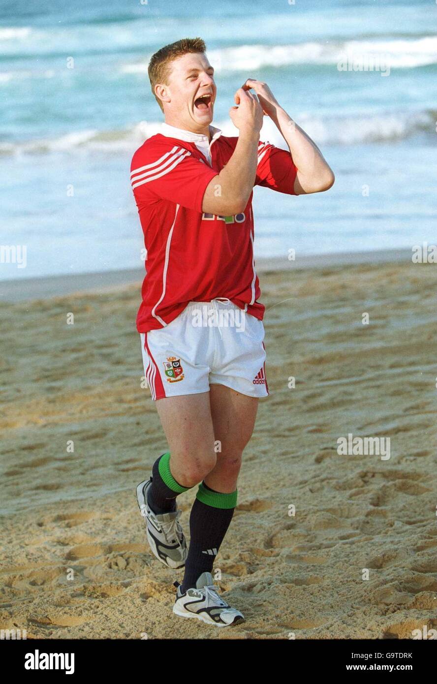 British Lions Brian O'Driscoll pretends to play the flute on the sand on Manly Beach as he fools around during a photo session. Stock Photo