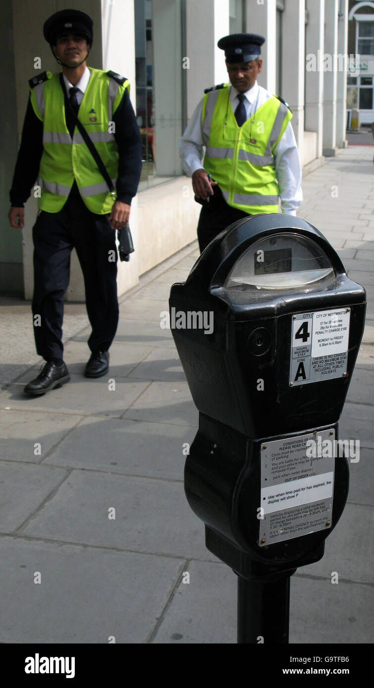 Parking meter stock. Generic stock picture showing a parking meter and traffic wardens in central London. Stock Photo