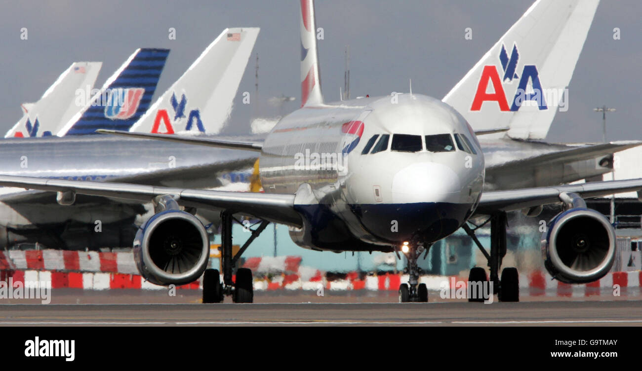 EU in row over 'open skies' air deal. A British Airways Airbus taxis pass tail fins of American Airlines and United Airlines at Heathrow Airport. Stock Photo