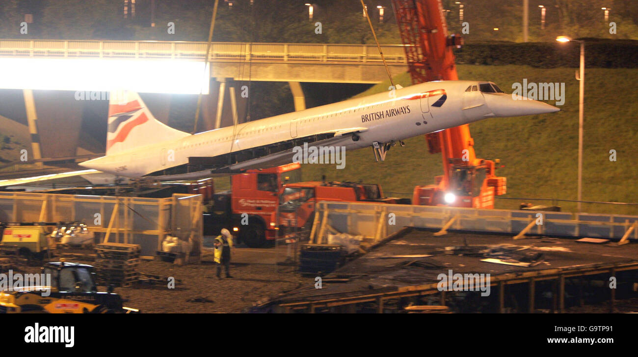 The model of a British Airways Concorde, that has stood at the entrance to London's Heathrow Airport, being lifted into the air before being placed on a flat-bed lorry during the early hours of Friday morning. Stock Photo