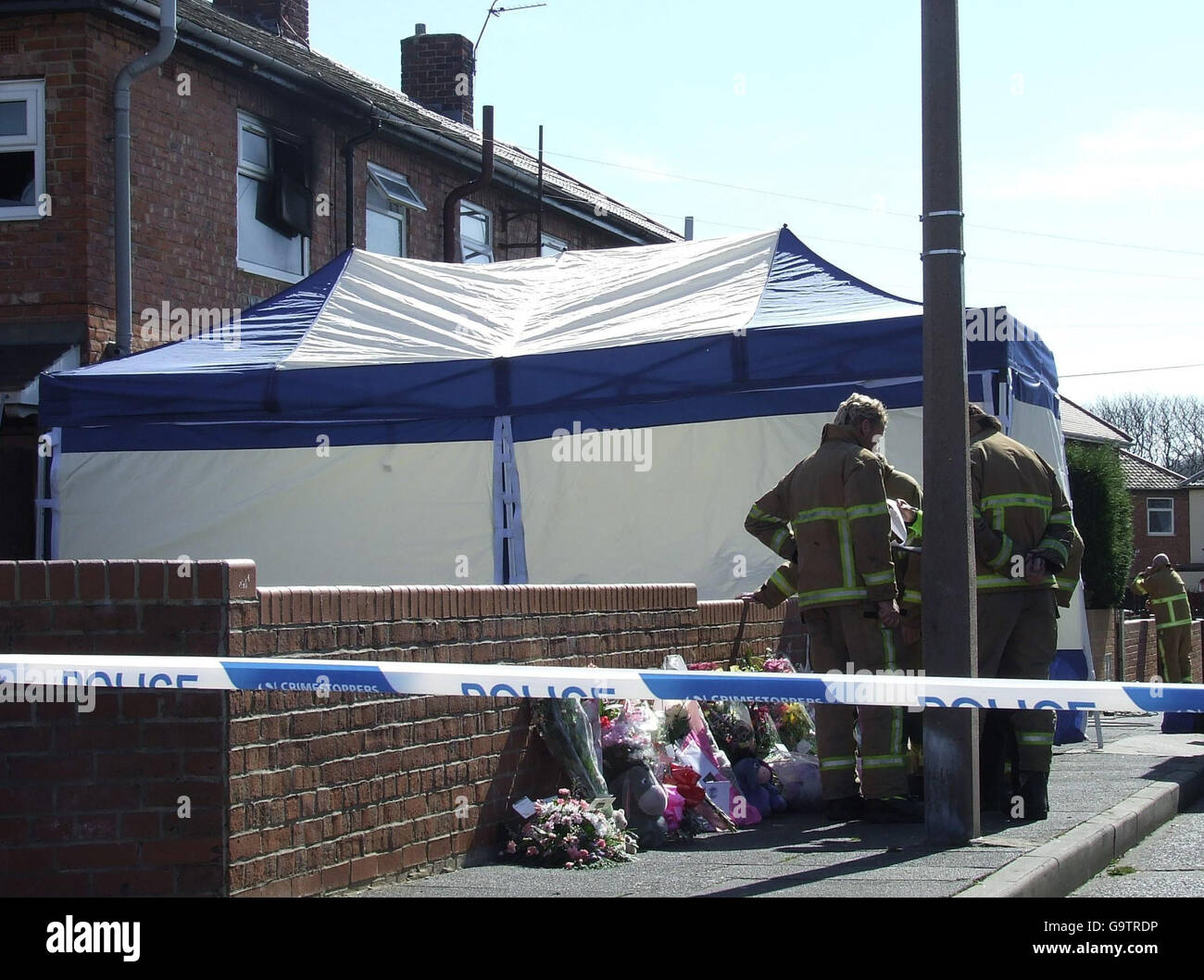 Two girls die in house fire. Flowers outside a house in Lisle Road