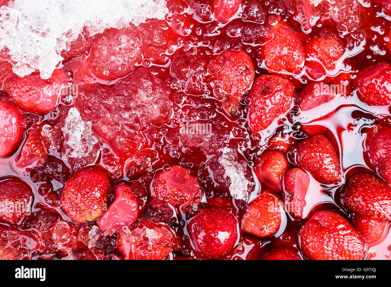 Strawberries floating on ice water Stock Photo Alamy