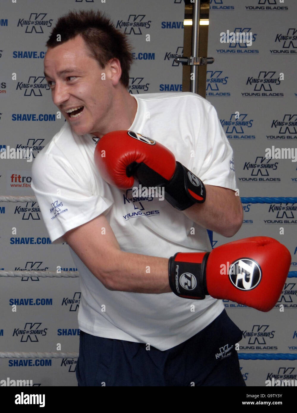 England football captain John Terry spars with young boxer Anthony Ogogo (not pictured) during a photo call in London. Stock Photo