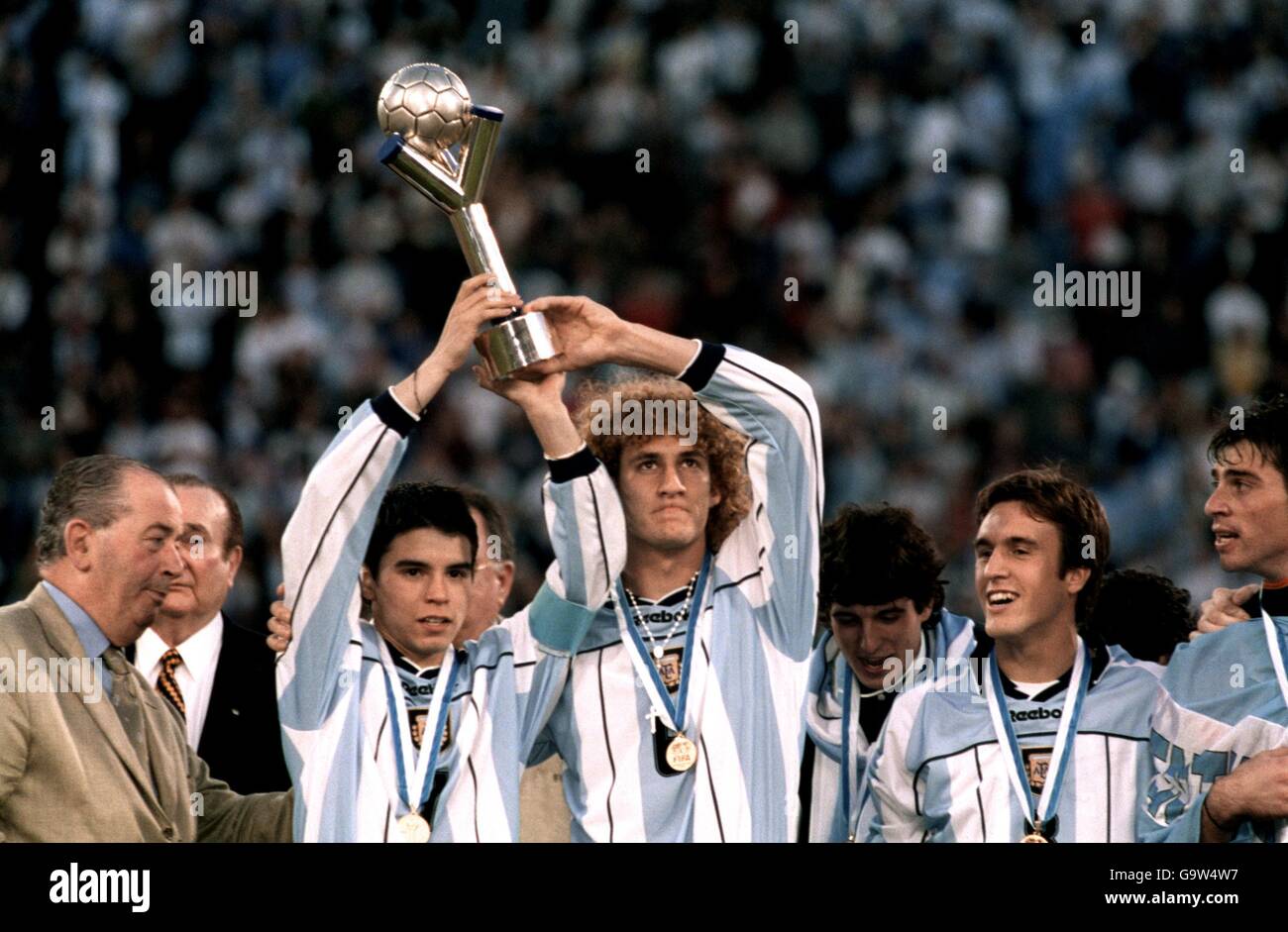 Argentina's Javier Saviola, left and Fabricio Coloccini lift the