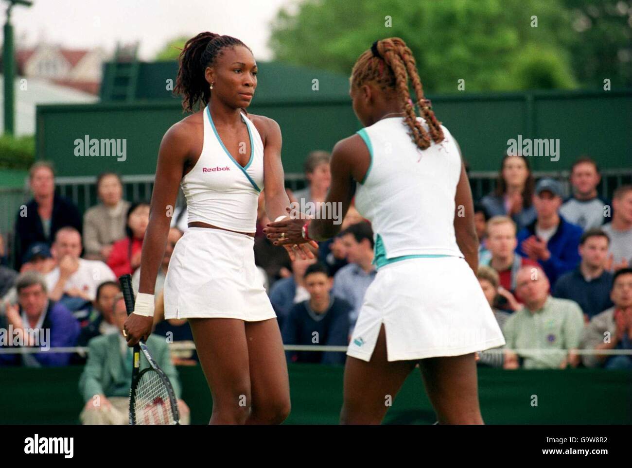 Venus (l) and Serena (r) Williams congratulate each other on winning a point Stock Photo