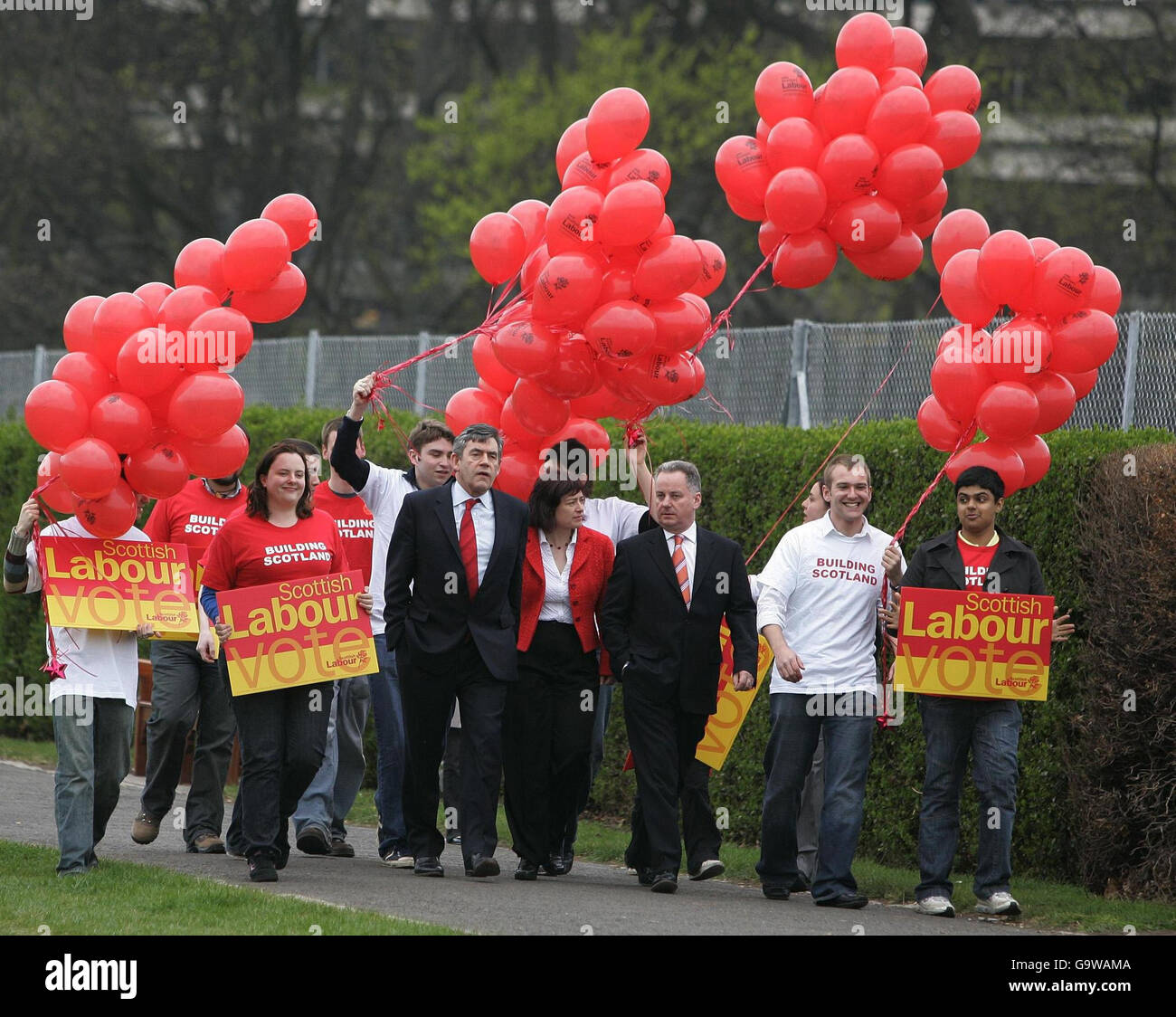 Scottish First Minister Jack McConnell (centre right) with Chancellor Gordon Brown (centre left) walking with campaigners in the Magnet Play Area in The Meadows in Edinburgh publicising Scottish Labour's pledges for families. Stock Photo