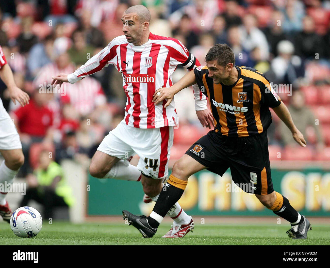 Stoke's Danny Higginbottom and Hull's Nicky Forster (right) battle for the ball during the Coca-Cola Football Championship match at the Britannia Stadium, Stoke. Stock Photo