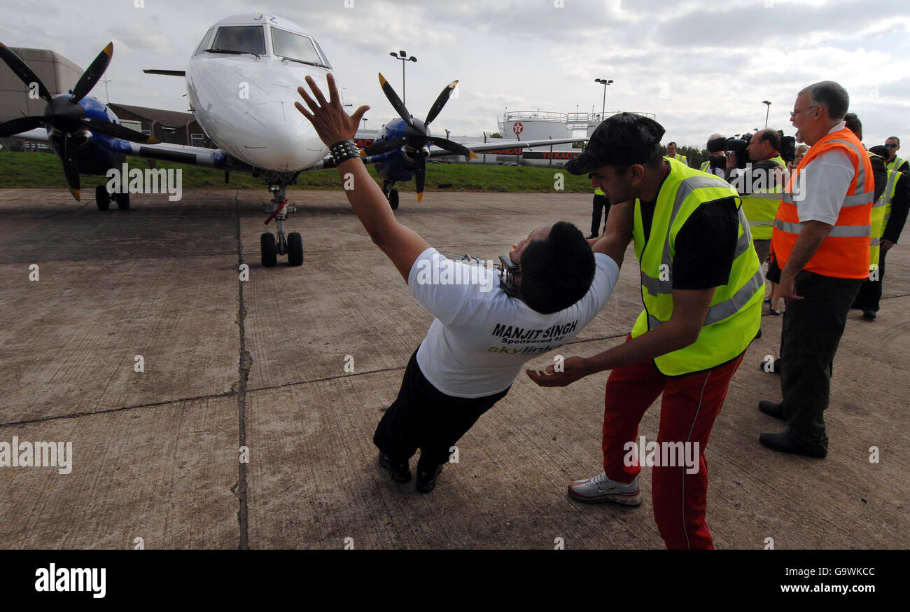 Man breaks record by pulling aircraft with his ears Stock Photo Alamy