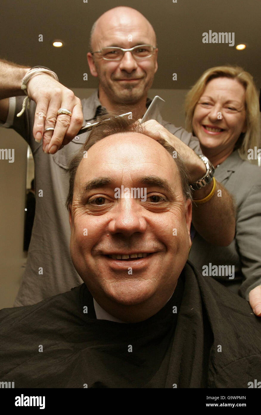 Scottish National Party leader Alex Salmond (front) with hairdresser David Miller and local candidate Linda Fabiani (right), during a walkabout East Kilbride prior to the Holyrood elections on Thursday. Stock Photo