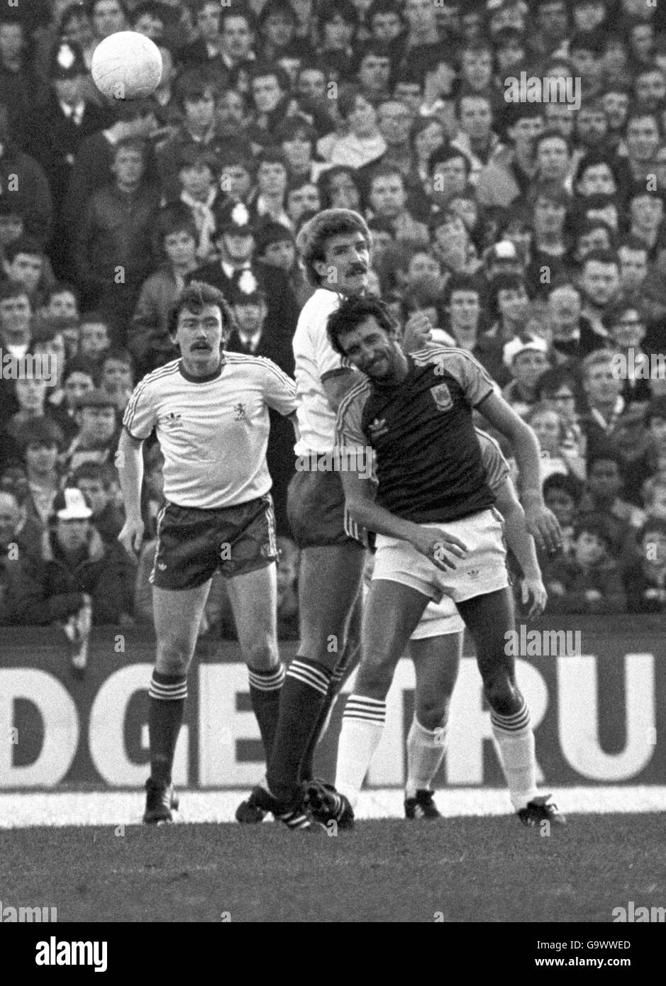 Michael Baxter backed up by Middlesbrough colleague Michael Angus (left) clears from the head of West Ham United striker David Cross (white shorts) during this afternoon's League Division One match at Upton Park Stock Photo
