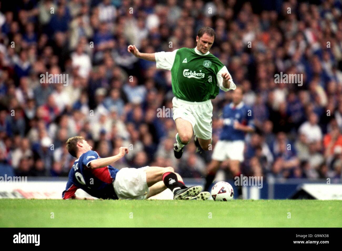 Scottish Soccer - Bank of Scotland Premier League - Rangers v Hibernian. Rangers Tore Andre Flo challenges Hibernian's John O'Neil. Stock Photo