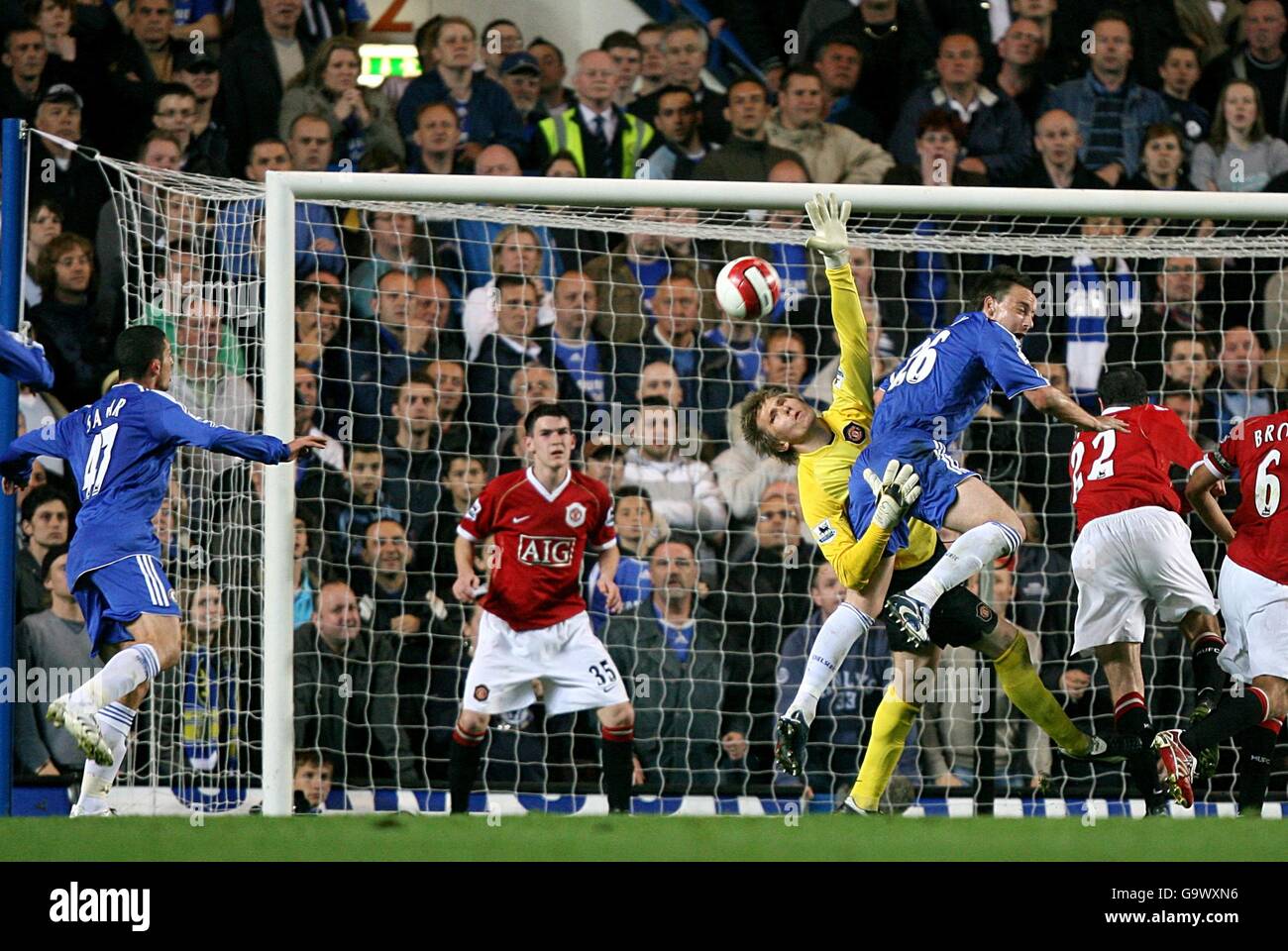 Chelsea's Ben Sahar (l) makes a shot on goal as Manchester United's goalkeeper Tomasz Kuszczak makes a save Stock Photo