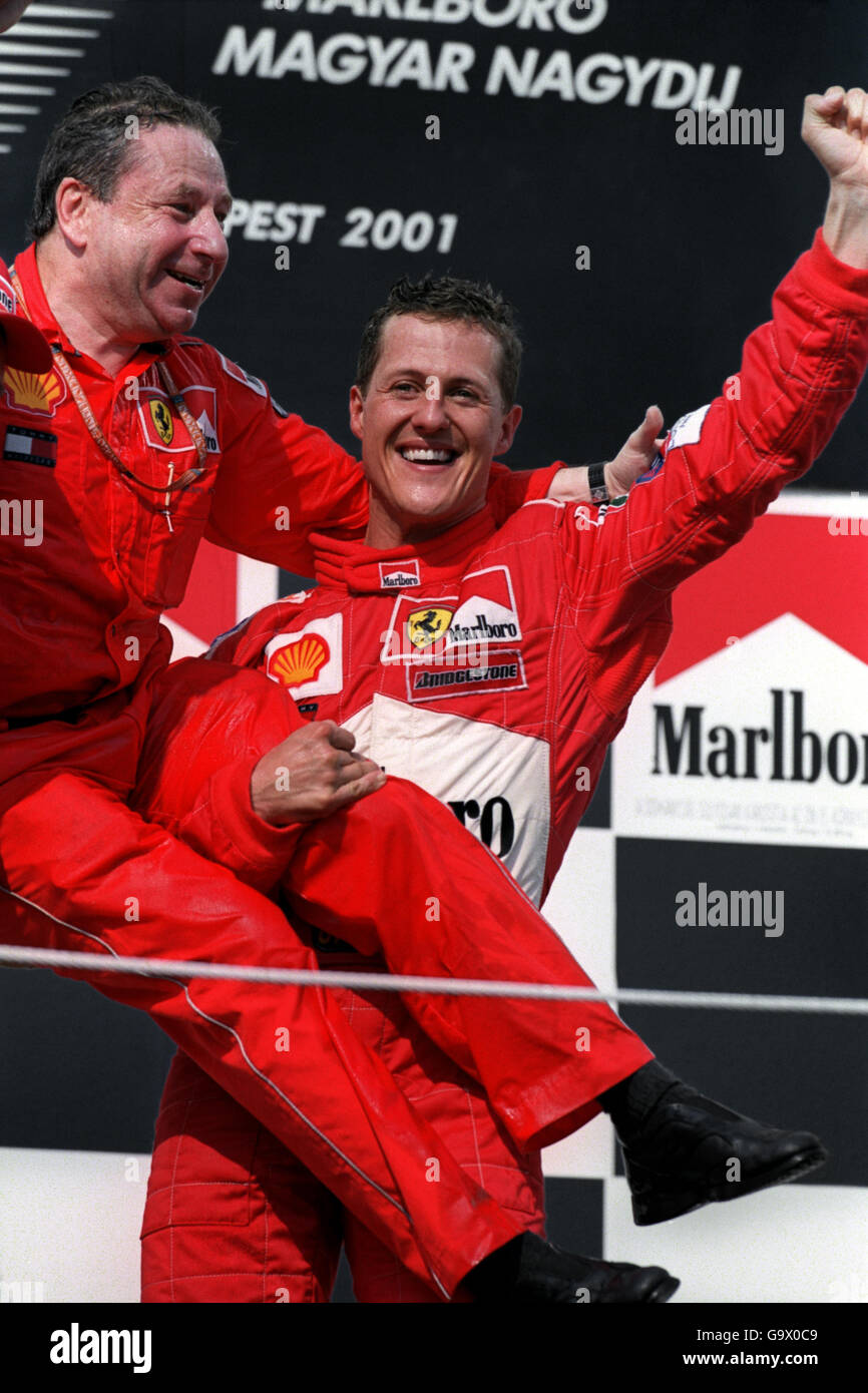 Michael Schumacher (r) celebrates winning the World Championship with Ferrari Sporting Director Jean Todt (c) Stock Photo