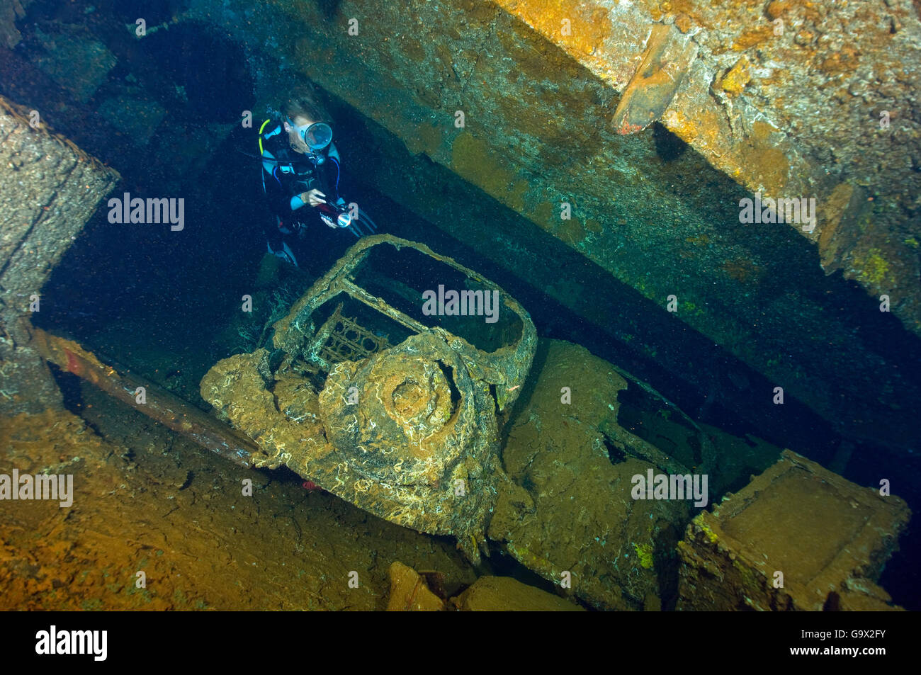 diver inside wreck of italian freighter Umbria with sunken FIAT cars ...