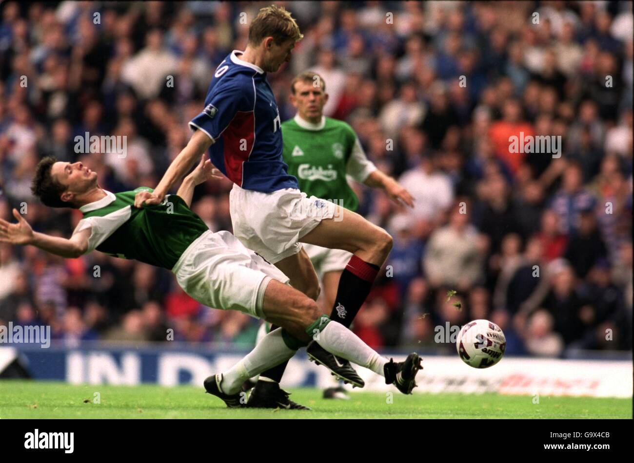 Scottish Soccer - Bank of Scotland Premier League - Rangers v Hibernian. Rangers' Tore Andre Flo (r) holds off Hibernian's Paul Fenwick (l) Stock Photo