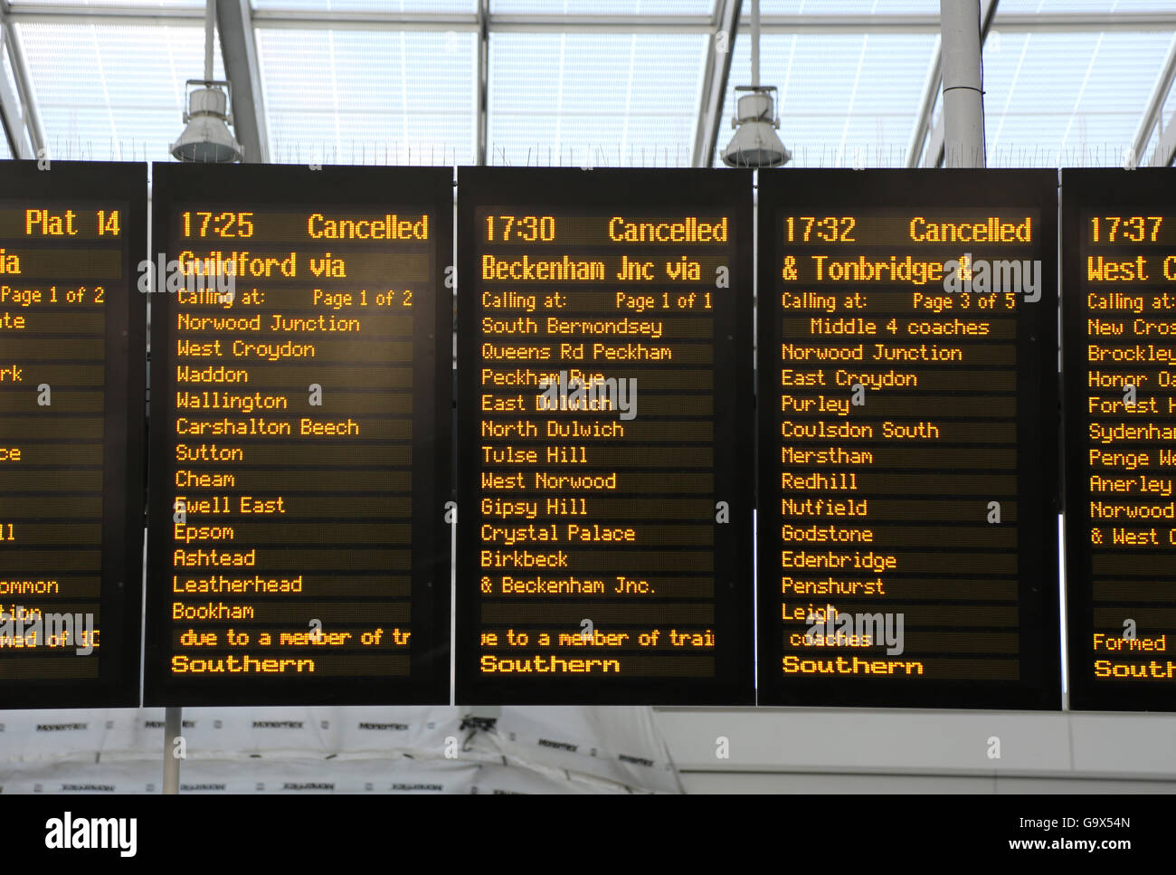 Southern train departure board at London Bridge station shows three cancelled rush-hour  trains on adjacent panels. Summer 2016 Stock Photo