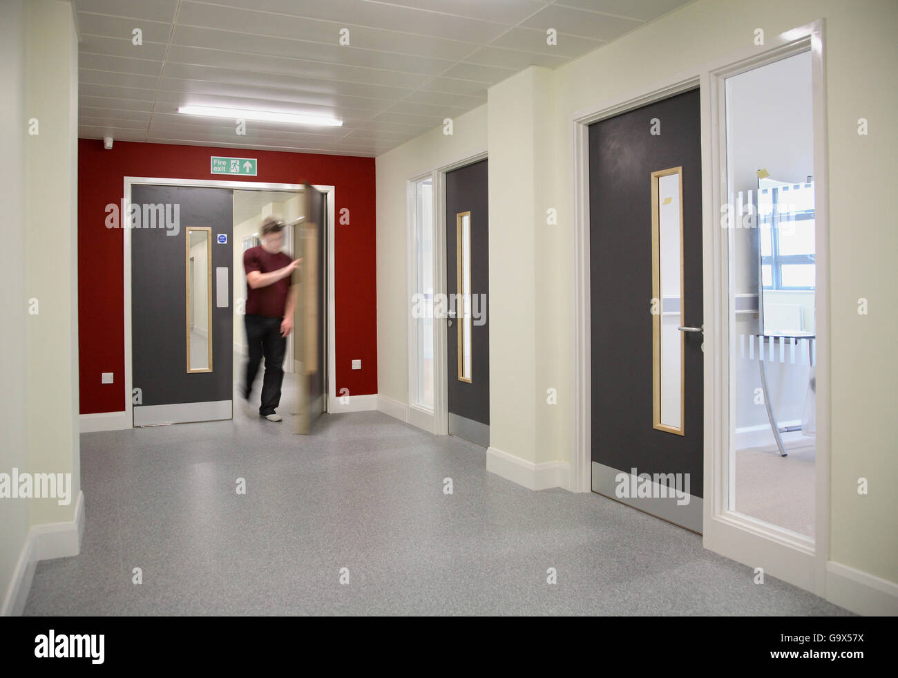 A student passes through a double door at the new Medway Campus building at Mid Kent further education college, Gillingham, Kent Stock Photo