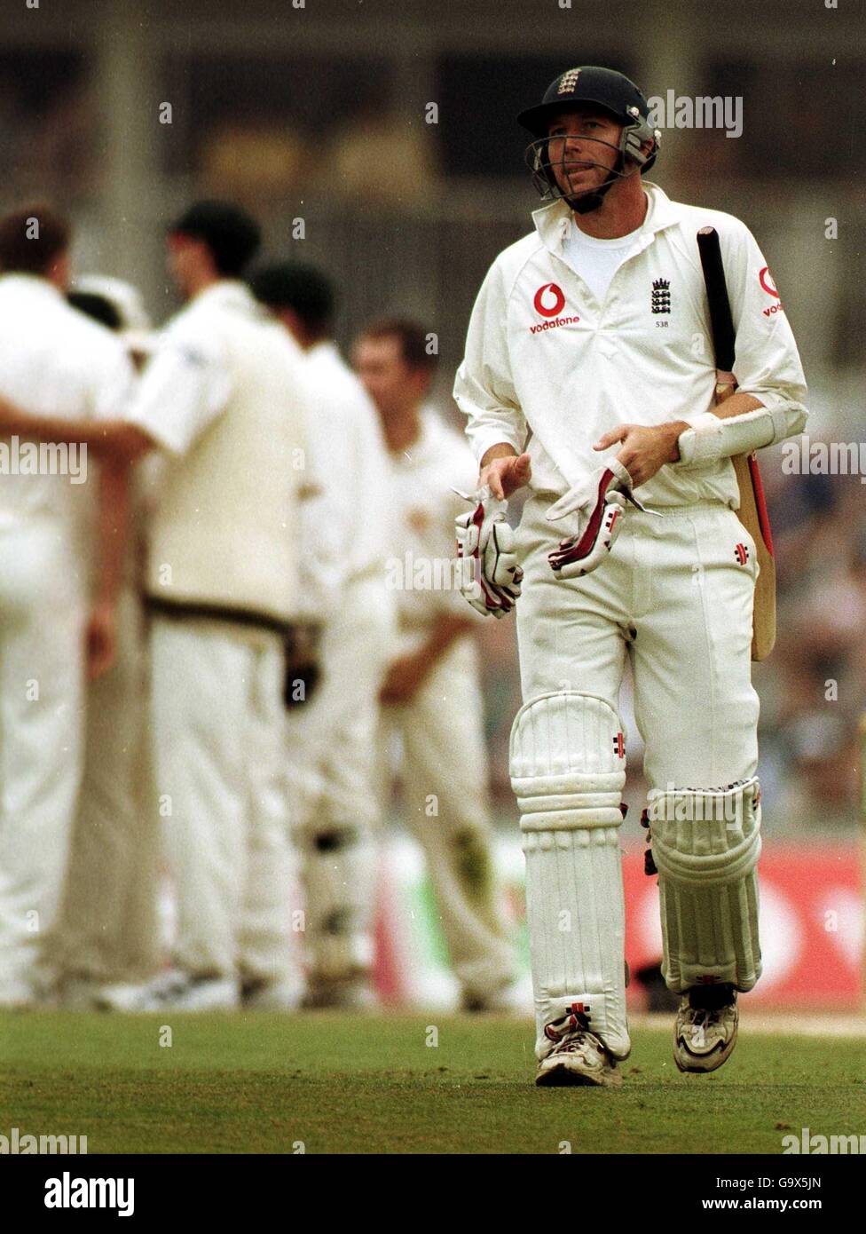 England's Michael Atherton takes his gloves off for possibly the last time, after he was caught behind by Shane Warne of the bowling from Glenn Mcgrath Stock Photo