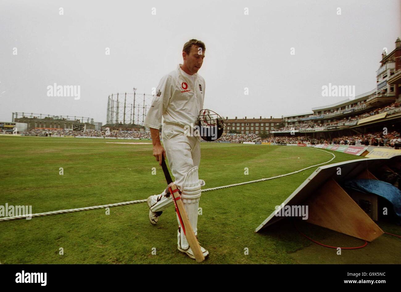 England's Michael Atherton leaves the pitch for possibly the last time, after he was caught behind by Shane Warne off the bowling from Glenn Mcgrath Stock Photo