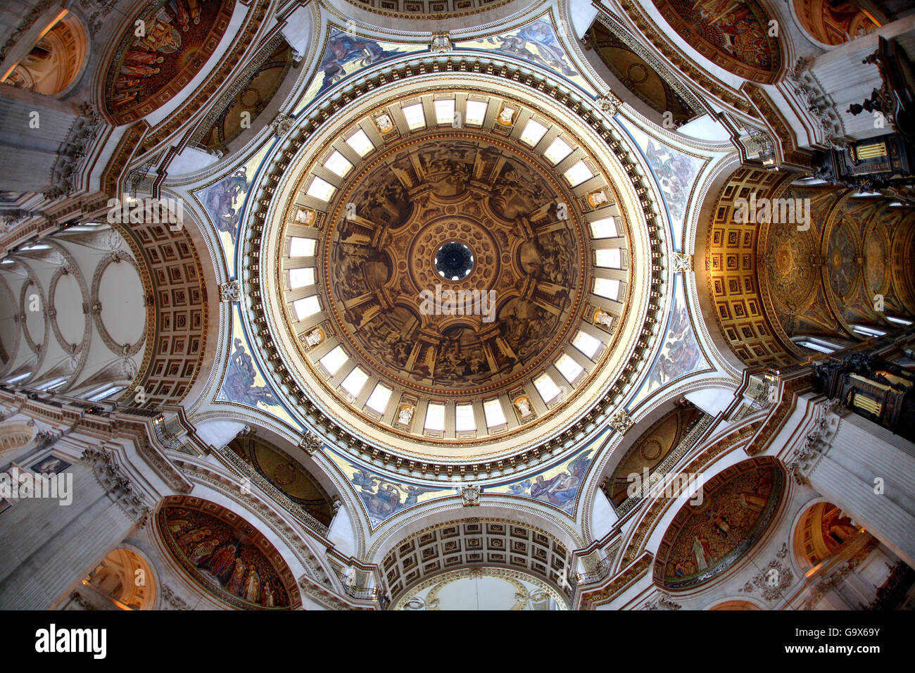 A fish-eye view directly upwards into the dome of St Pauls Cathedral, London, UK. Shows roof of nave to left and chancel right Stock Photo