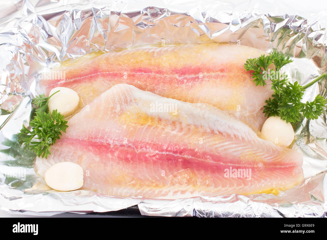 Catfish Fillets with Olive Oil, Garlic and Parsley in Foil, Ready for
