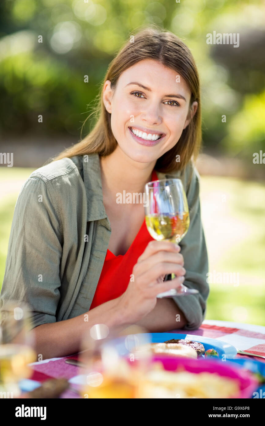 Portrait of woman holding wine glass and smiling Stock Photo - Alamy