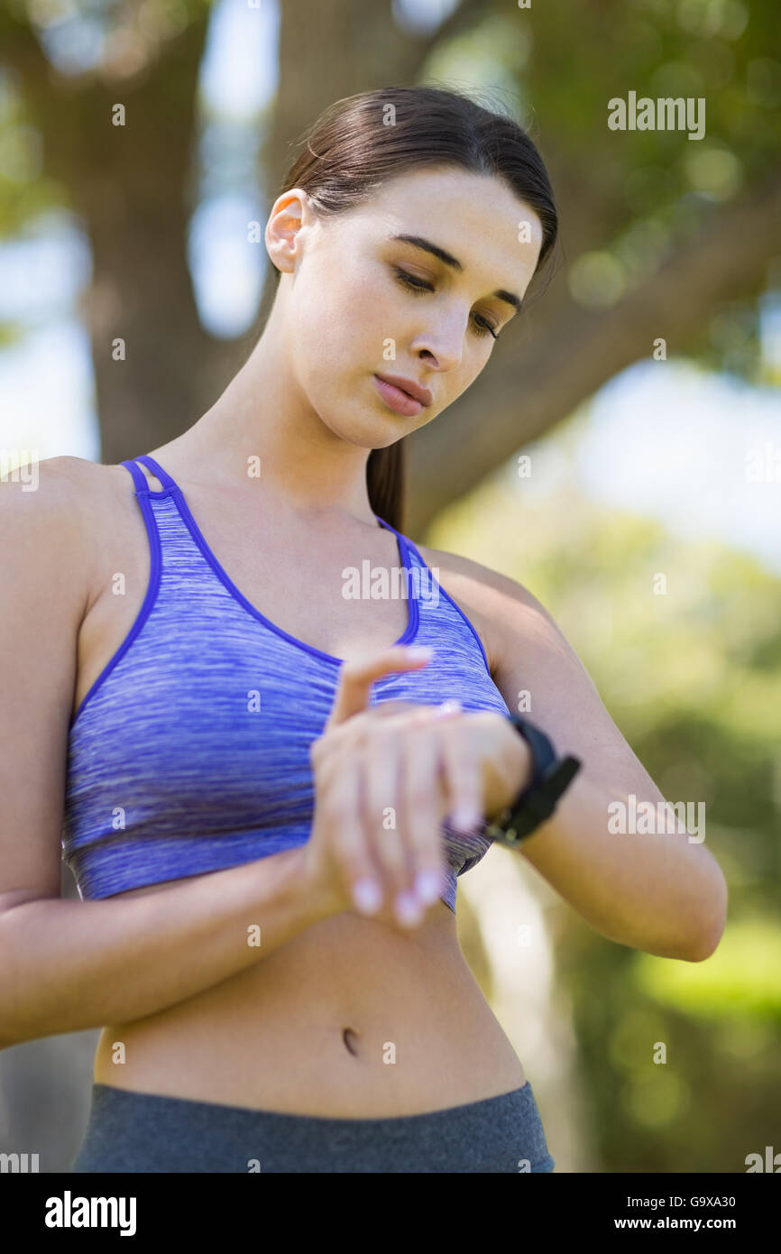 Woman checking time while exercising Stock Photo