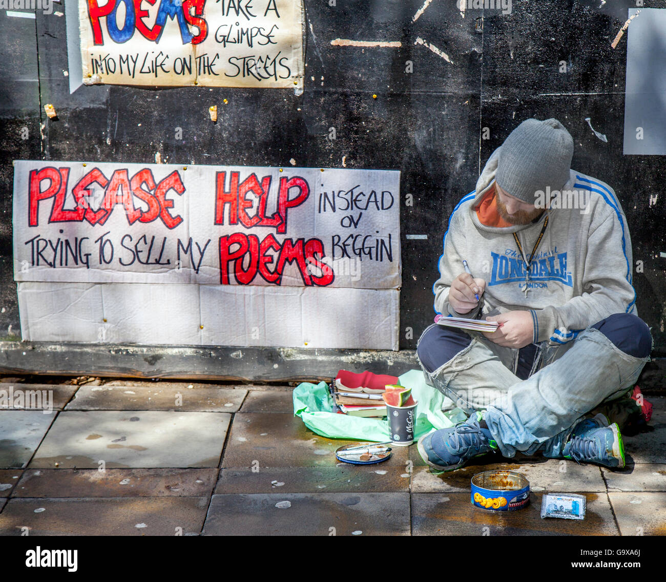 Helping the homeless. A rough sleeper, a seated man not begging, but