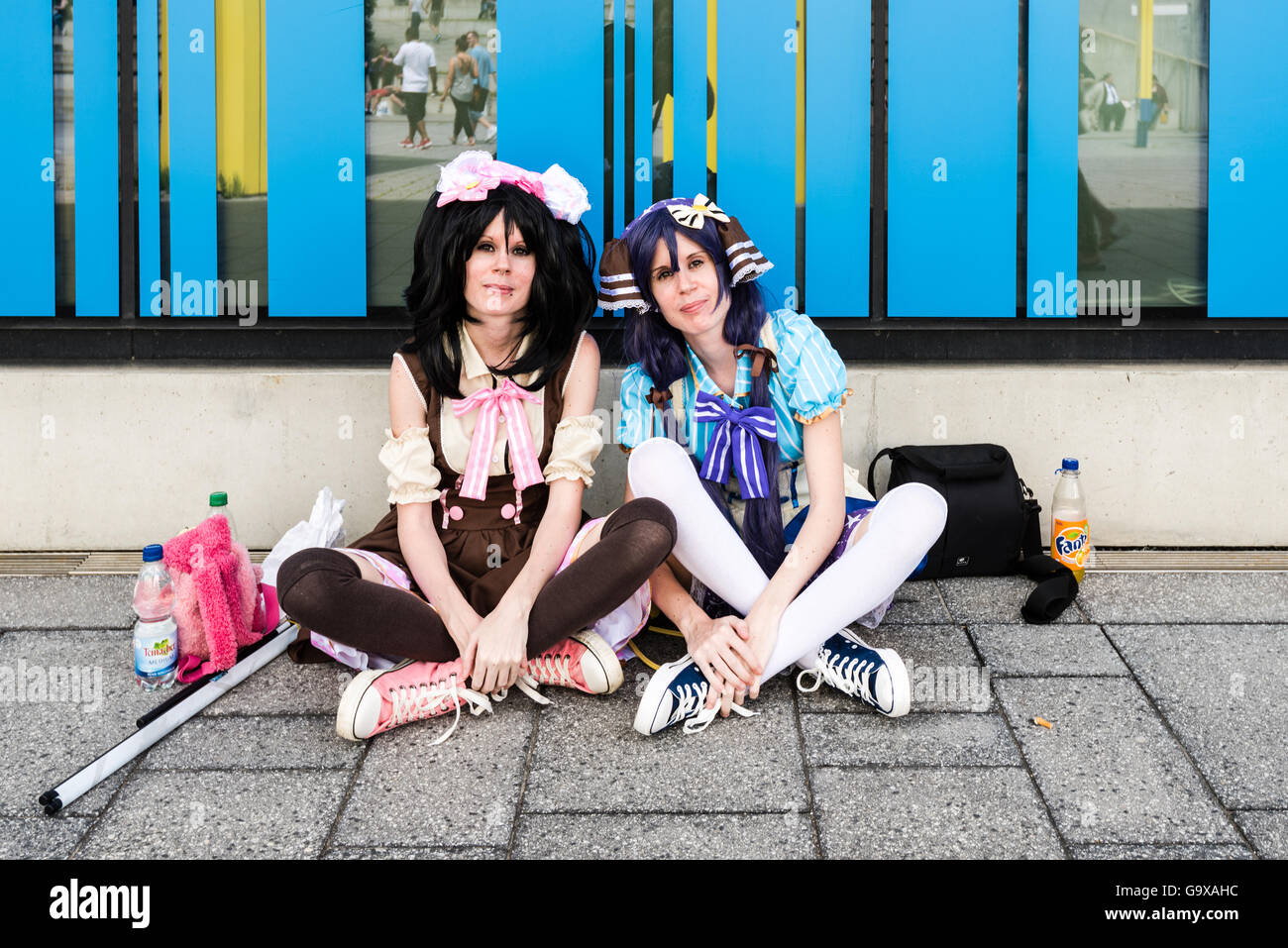 Stuttgart, Germany - June 25, 2016: Two female cosplayers are resting during the Comic Con Germany event in Stuttgart in front o Stock Photo