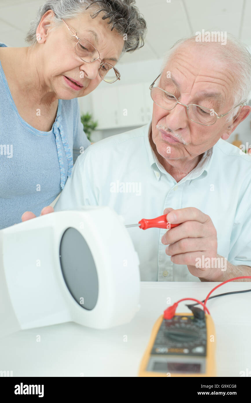 elderly man fixing a coffee machine Stock Photo Alamy