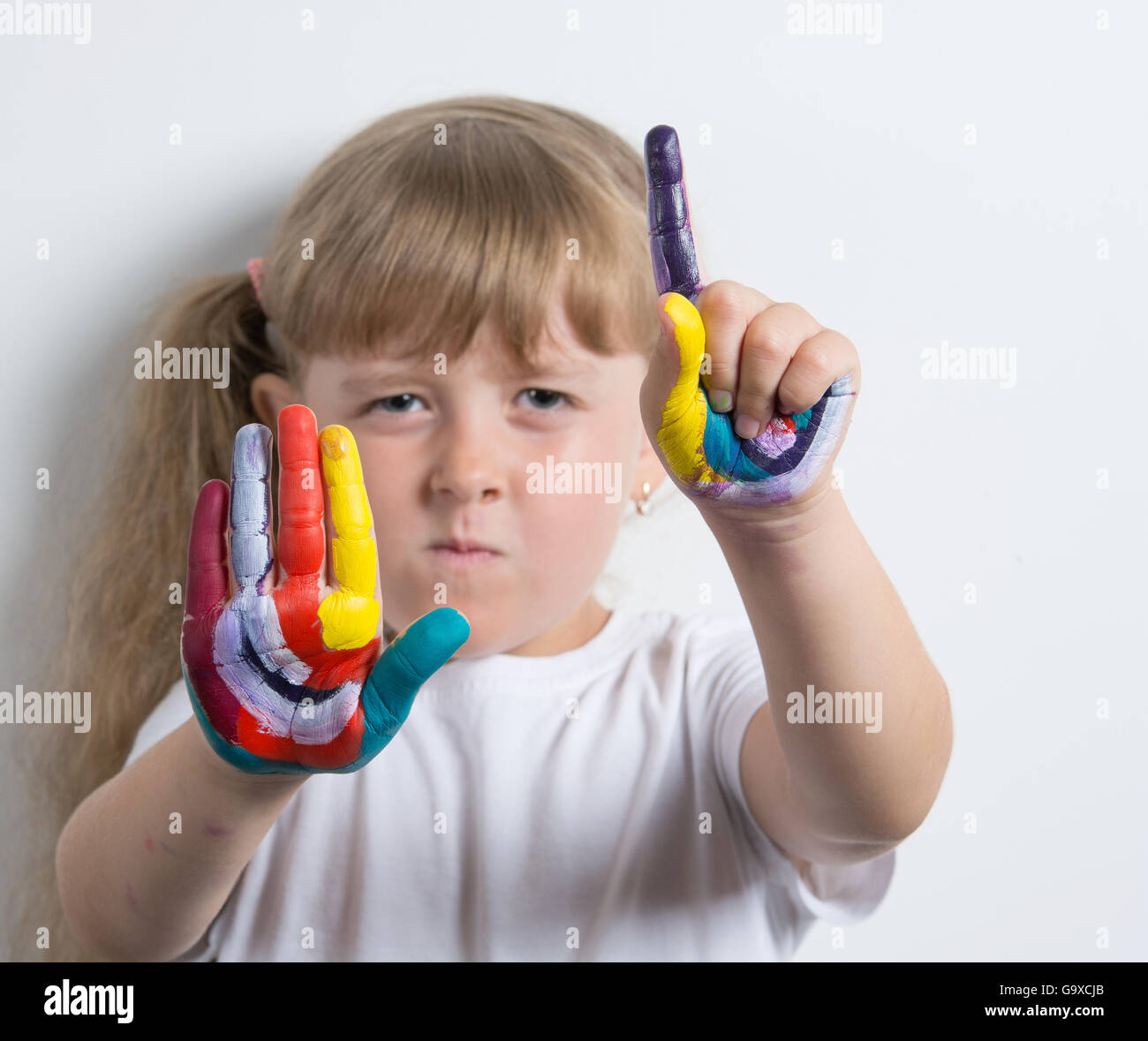 girl with bright painted palms Stock Photo