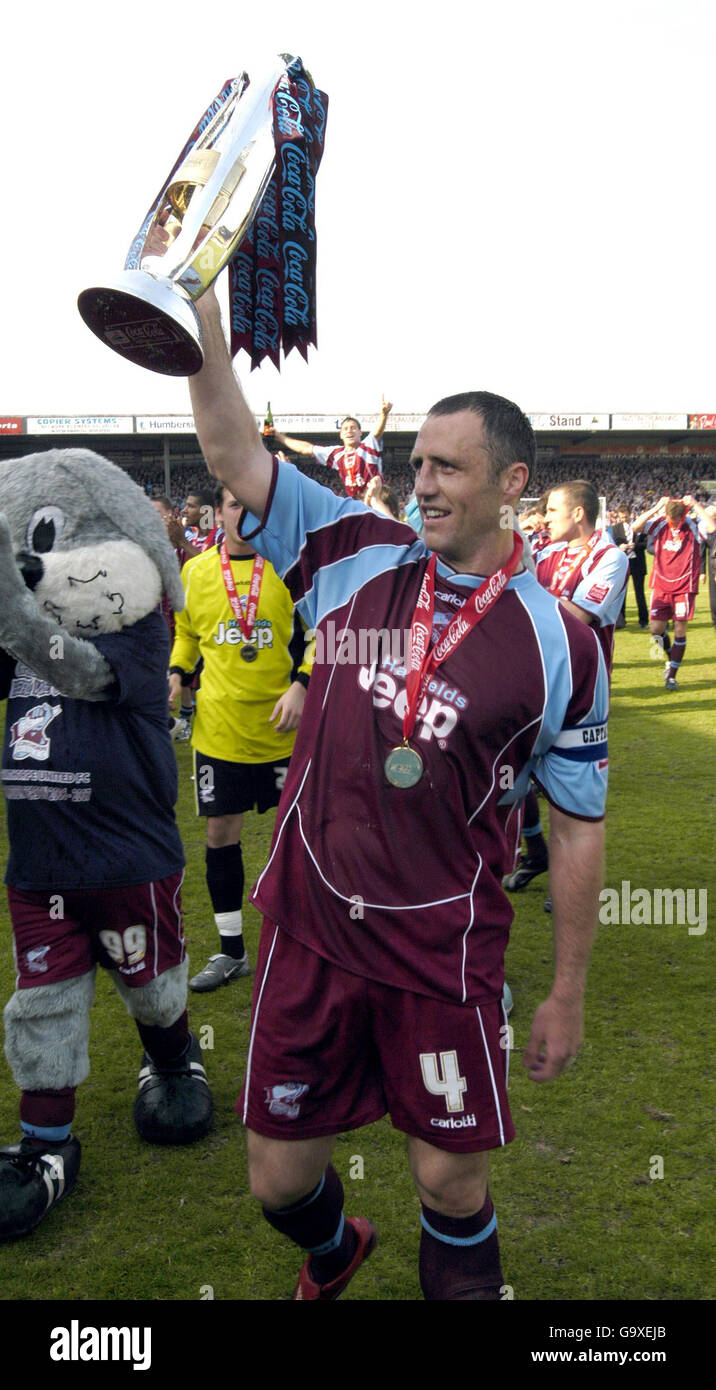 Scunthorpe's captain Andy Crosby holds the League One trophy aloft following the Coca-Cola Football League One match at Glanford Park, Scunthorpe. Stock Photo