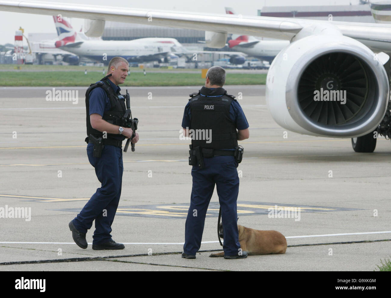 Armed police officers stand nearby as Britain's Prime Minister Tony Blair prepares to board a Boeing 737 flight to Washington, USA. Stock Photo