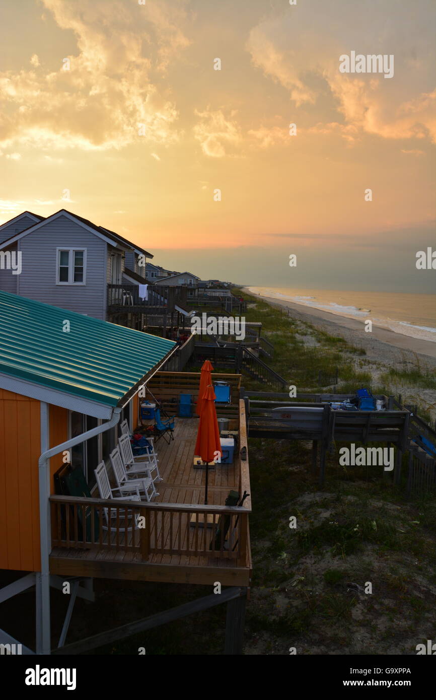 Storm Clouds At Sunrise Over The Beach Cottages On The Atlantic On