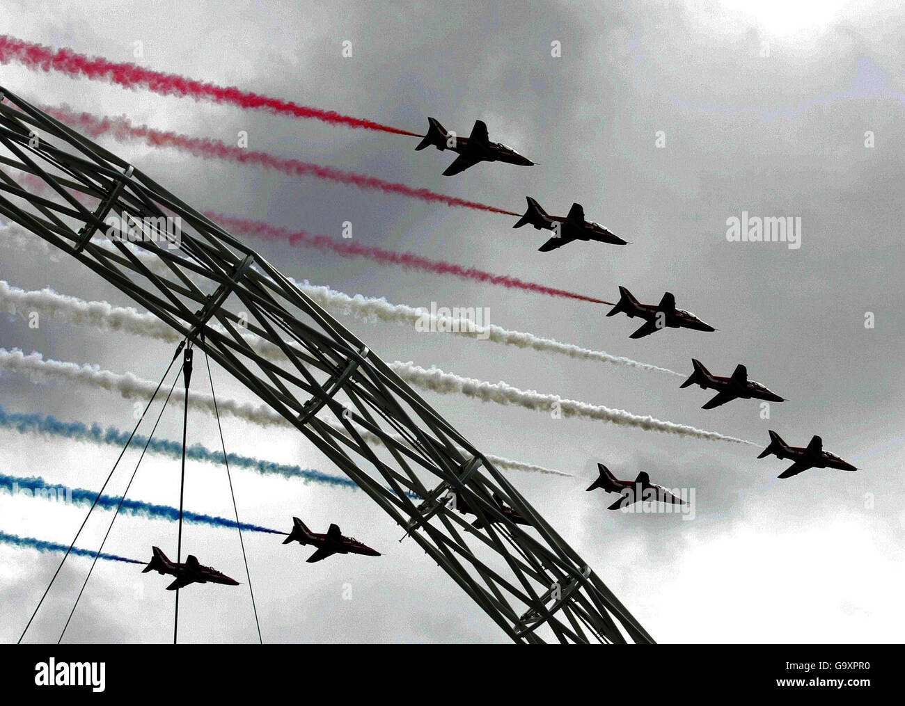 The Red Arrows fly over Wembley Arch at the new Wembley Stadium in north London. Stock Photo