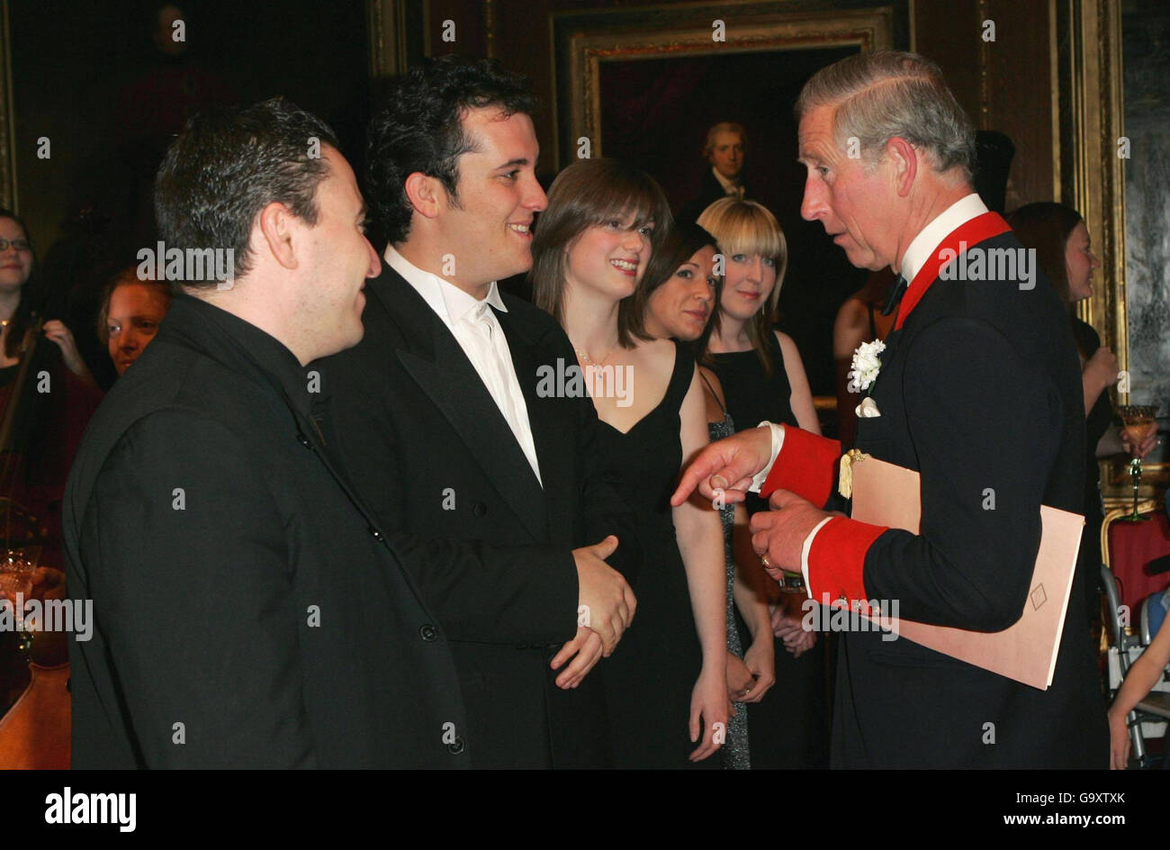 The Prince of Wales Prince of Wales meets Maxin Vergerov, a violinist, and Igor Levit, a pianist who were the main preformers at a concert in which celebrated the 30th anniversary of Live Music Now at Windsor Castle. Stock Photo