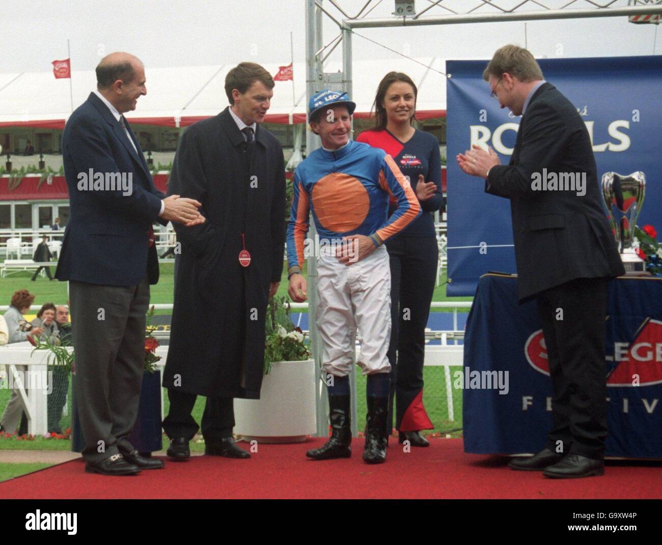 Mick Kinane receives the applause of both the owner and trainer of ...