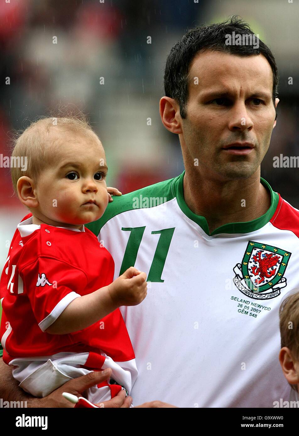 Soccer - International Friendly - Wales v New Zealand - Racecourse Ground. Wales' Ryan Giggs with mascot prior to kick off Stock Photo