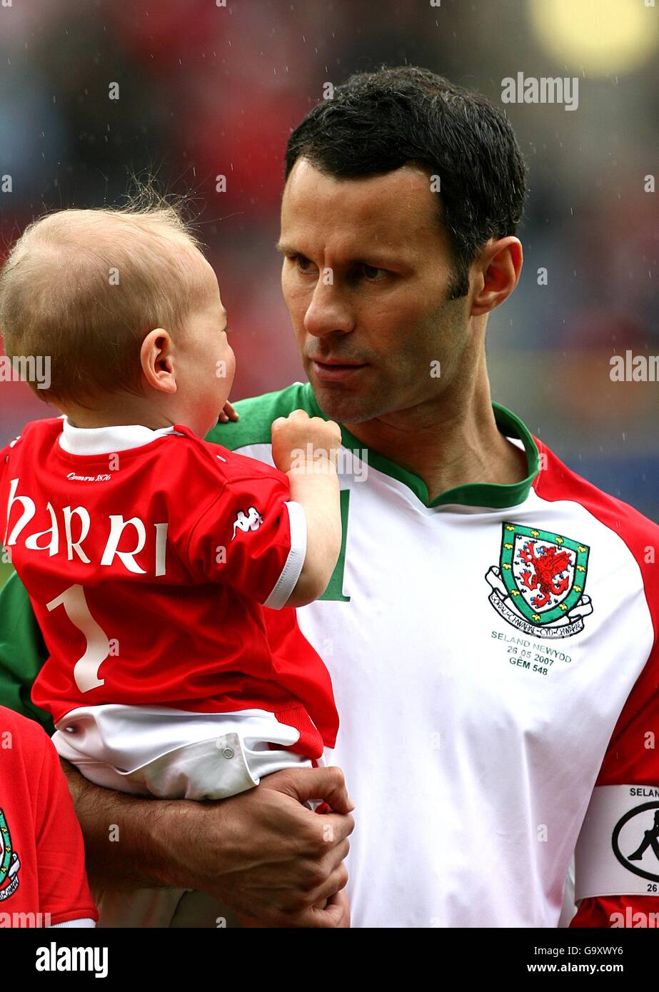 Soccer - International Friendly - Wales v New Zealand - Racecourse Ground. Wales' Ryan giggs with the mascot prior to kick off Stock Photo