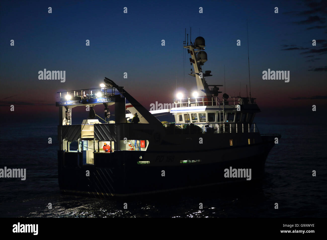 Fishing vessel &#39;Ocean Harvest&#39; trawling at dusk, North Sea, May 2014. Property released. All non-editorial uses must be cleared individually. Stock Photo