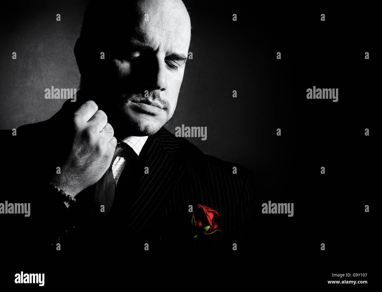 Portrait of man, godfather-like character. Black and white studio shot. Stock Photo