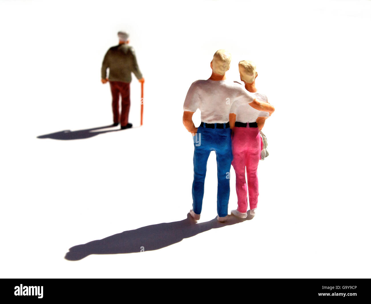 Miniature figurines, couple watching elderly man Stock Photo