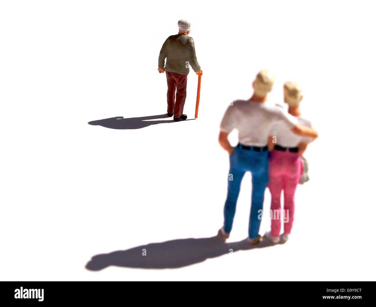 Miniature figurines, couple watching elderly man Stock Photo