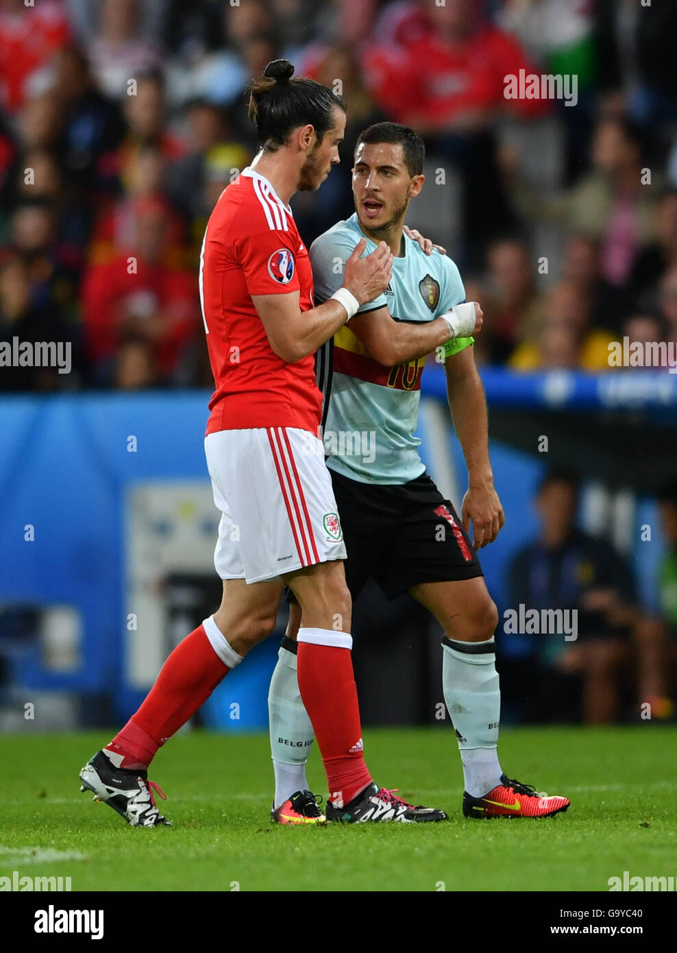 Lille, France. 1st July, 2016. Gareth Bale (L) of Wales talks with Eden  Hazard of Belgium during the Euro 2016 quarterfinal match between Belgium  and Wales in Lille, France, July 1, 2016.
