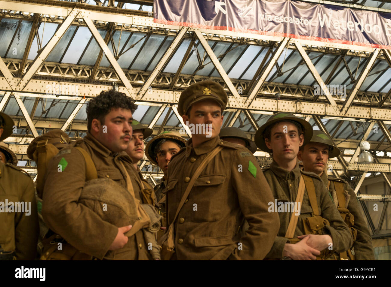 London, UK. 1st July, 2016. A silent tribute by men dressed as First World War Soldiers at Waterloo Station to mark the 100th anniversary of the beginning of the Battle of the Somme.   Credit:  claire doherty/Alamy Live News Stock Photo
